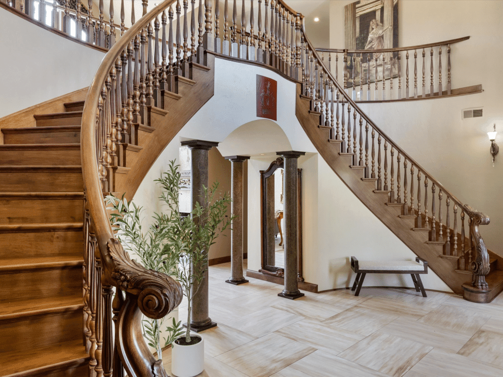 Ornate double staircase in luxury vacation rental mansion on the lake near Newton, WI