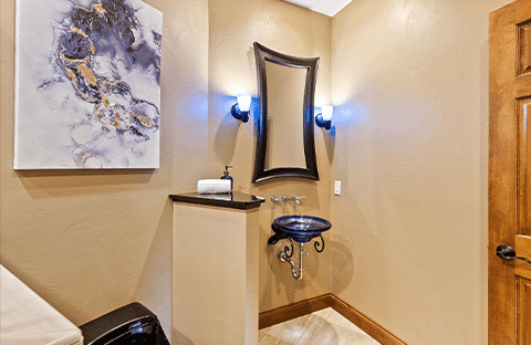 Convenient full bathroom with tile shower and amenities at Mansion on the Lake in Newton, WI, ideal for guests near the pool and gym