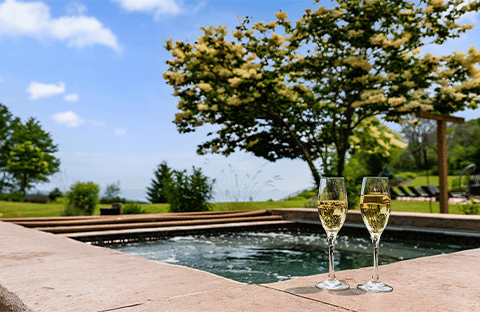 Outdoor hot tub with views of Lake Michigan, located between the Summer House and pool at Mansion on the Lake in Newton, W