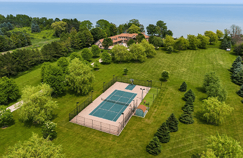Aerial view of private luxury tennis court at Mansion on the Lake in Newton, WI, near Chicago and Milwaukee