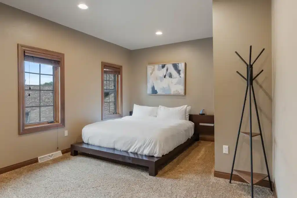 Huron Hideaway room at Mansion on the Lake with king-size bed, large closet, and windows providing natural light