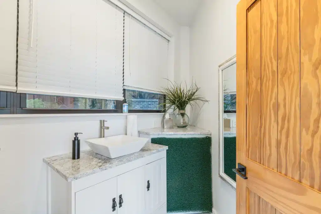 Bathroom inside the Summer House at Mansion on the Lake with convenient amenities for poolside guests