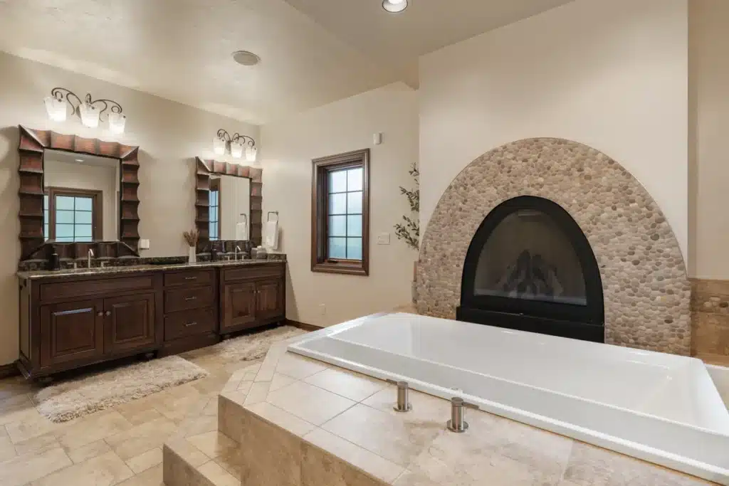 Luxurious bathtub in the Lakeside Retreat bathroom at Mansion on the Lake with a fireplace and elegant surroundings
