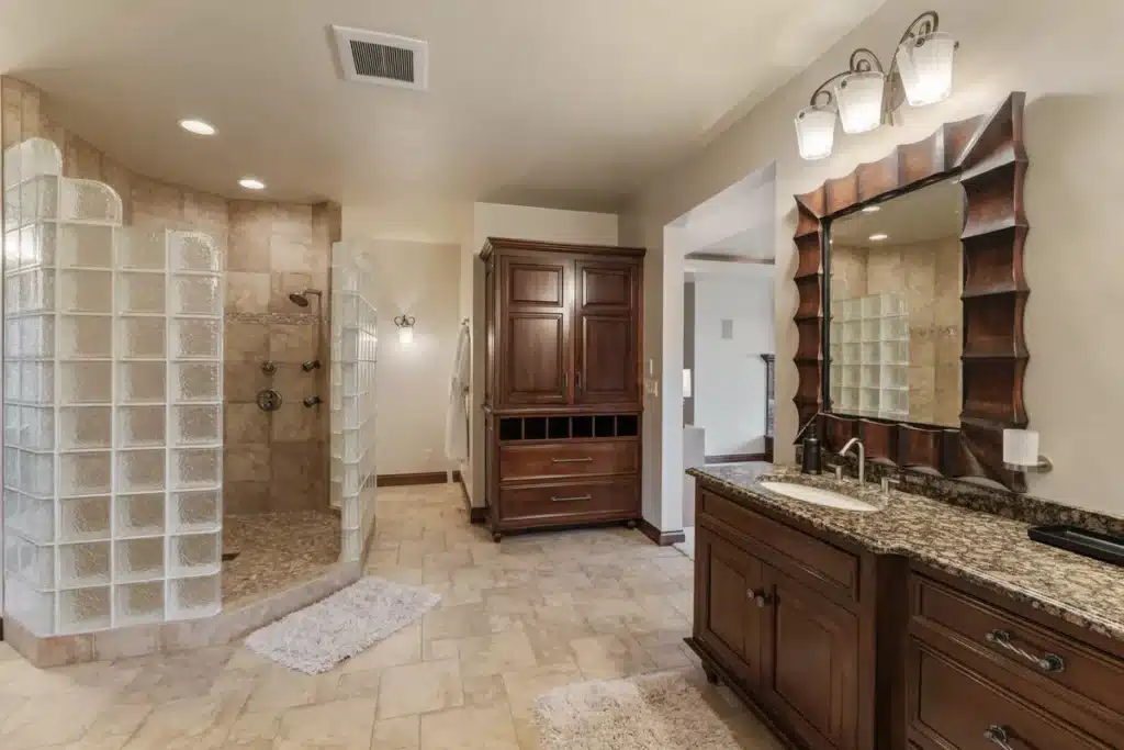 Lakeside Retreat bathroom at Mansion on the Lake with glass-enclosed shower and elegant dual-sink vanity