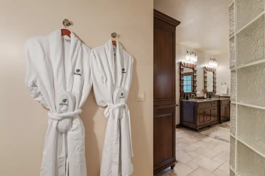 Lakeside Retreat bathroom at Mansion on the Lake with plush robes and a view of the glass-enclosed shower