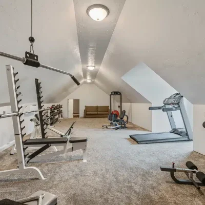 Workout room at Mansion on the Lake with treadmill, leg press, weight bench, and additional exercise equipment