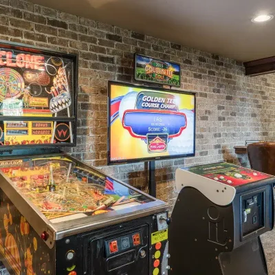 Game room at Mansion on the Lake featuring Cyclone and Golden Tee arcade games for added entertainment