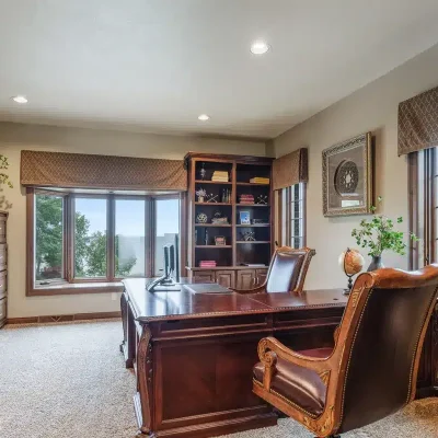 Executive office at Mansion on the Lake with expansive Lake Michigan view, comfortable seating, and work desk