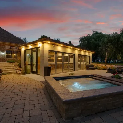 Beautiful sunset over Lake Michigan with the Summer House, hot tub, fireplace, and Mansion on the Lake lit up in the background