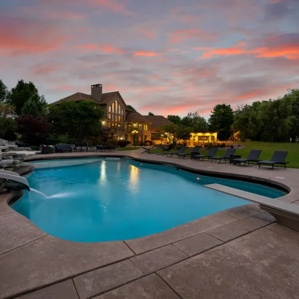 Luxurious outdoor swimming pool surrounded by manicured gardens at Mansion on the Lake, perfect for relaxation and family bonding in a private, exclusive setting. Crystal-clear water, cozy poolside loungers, and breathtaking lake views create an oasis for ultimate leisure and rejuvenation.