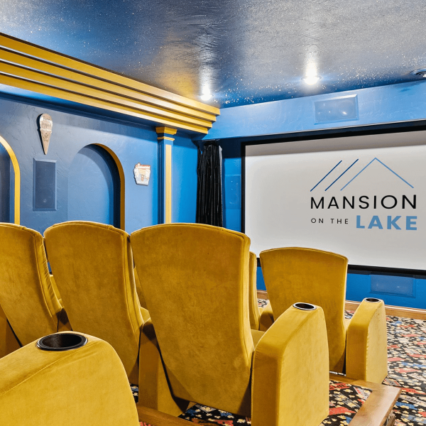 Theater room at Mansion on the Lake with plush seating, state-of-the-art audio-visual equipment, and large screen